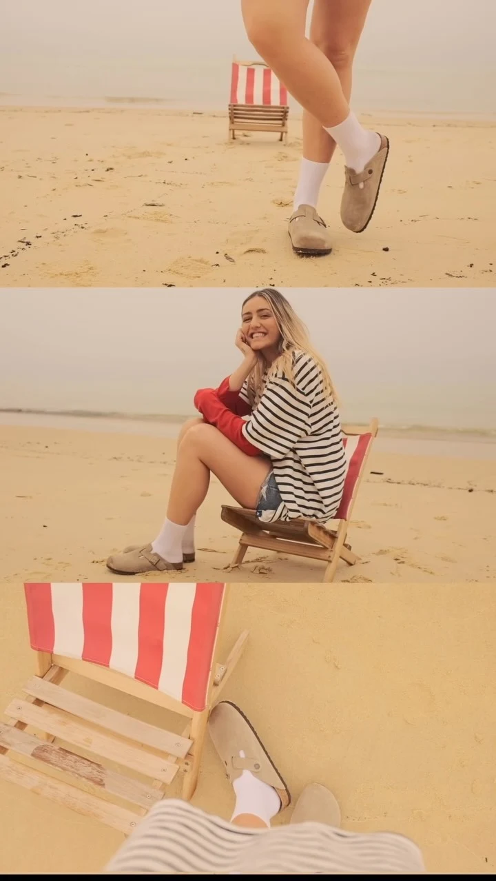 Person wearing a striped tee over a red long-sleeve, denim shorts, white socks, and tan Boston clogs.