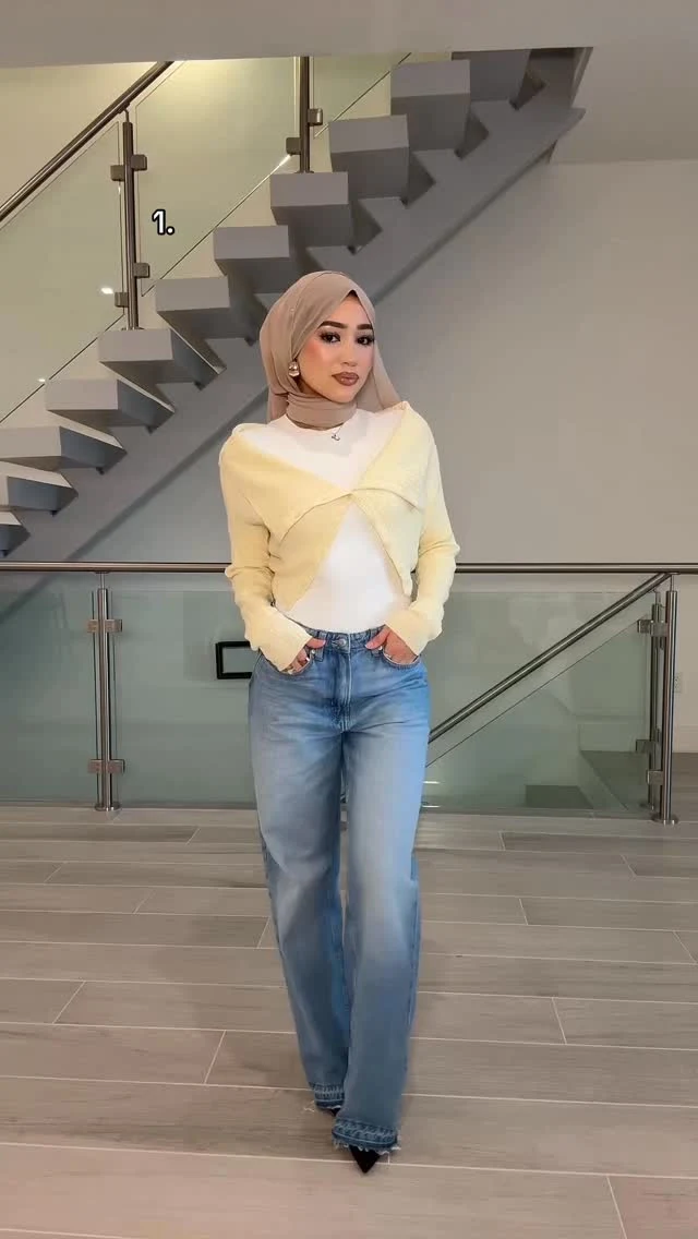 Pale yellow cable-knit cardigan over white top, light-wash wide-leg jeans, and black heels.