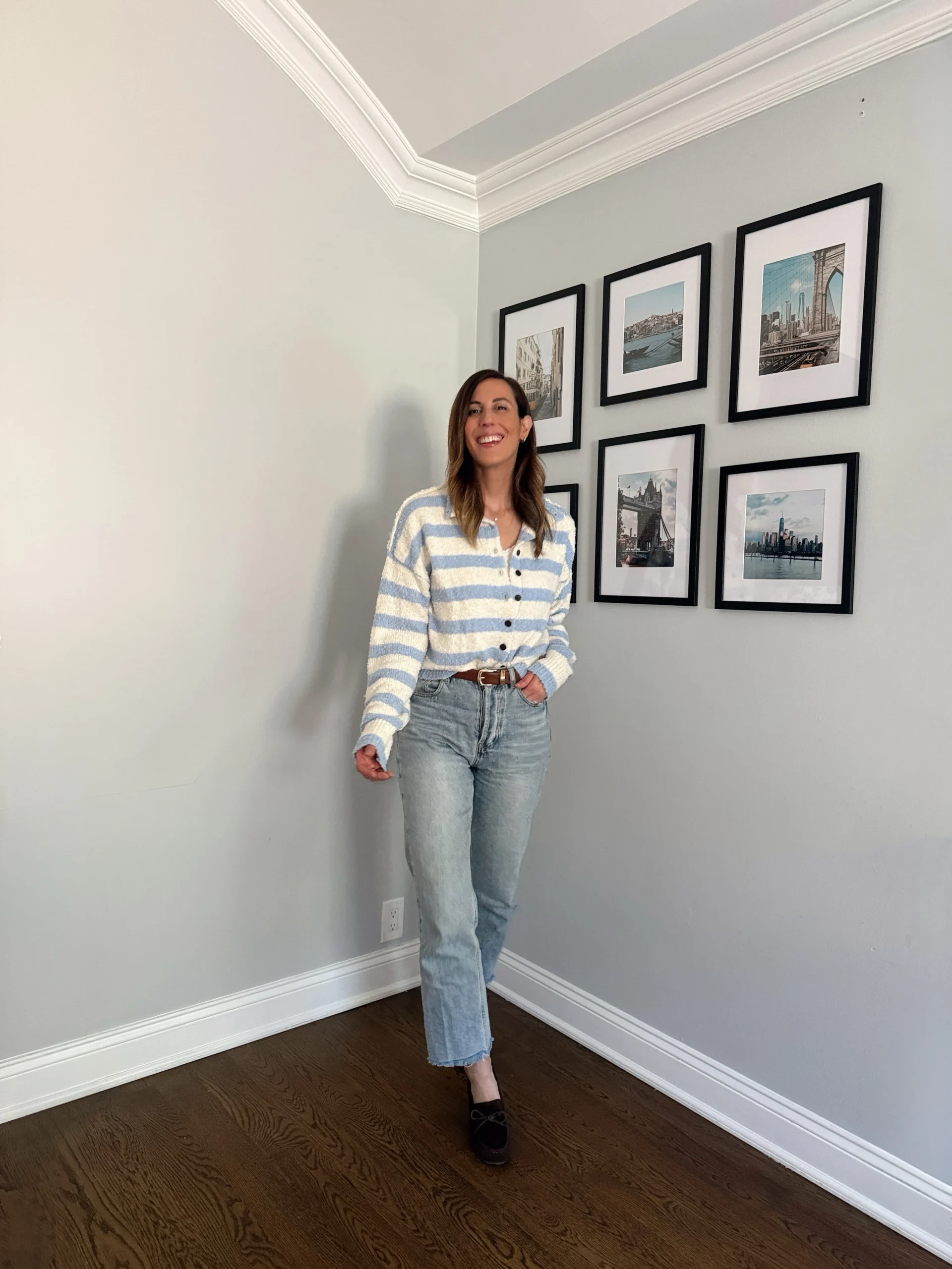Blue and white fuzzy striped cardigan over light-wash jeans with a brown belt and dark loafers.